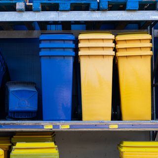 Yellow and blue rubbish bins on shop shelf