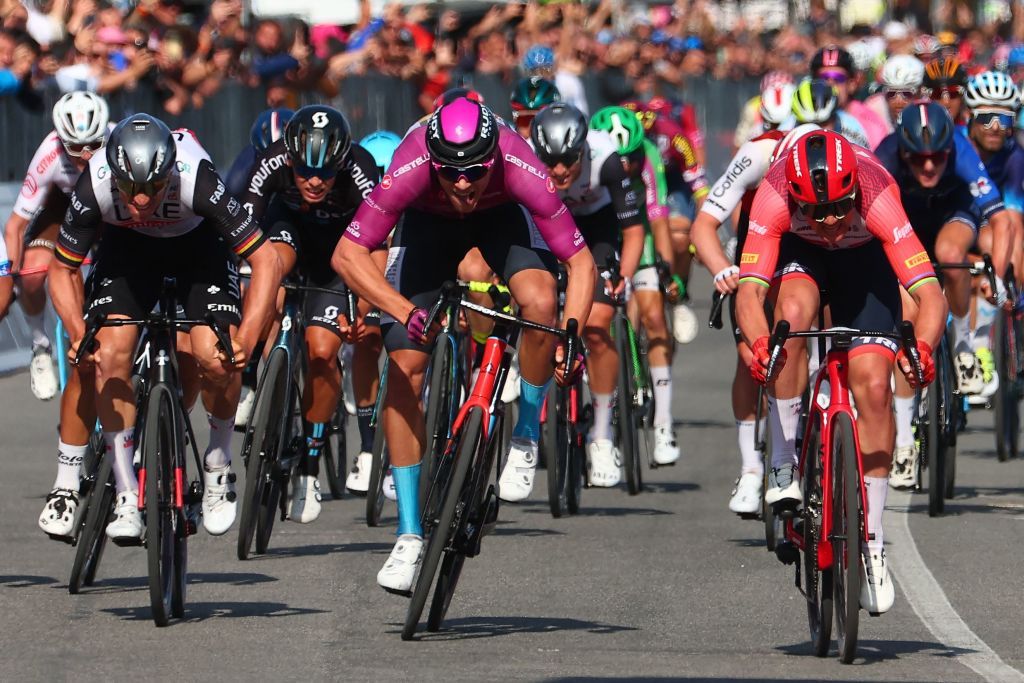 Trek Segafredos Danish rider Mads Pedersen R sprints ahead of secondplaced Bahrain Victoriouss Italian rider Jonathan Milan C and thirdplaced UAE Team Emiratess German rider Pascal Ackermann L to the finish line to win the sixth stage of the Giro dItalia 2023 cycling race 162 km between Naples and Naples on May 11 2023 Photo by Luca Bettini AFP Photo by LUCA BETTINIAFP via Getty Images