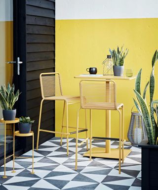 geometric patio design and yellow wall with habitat furniture