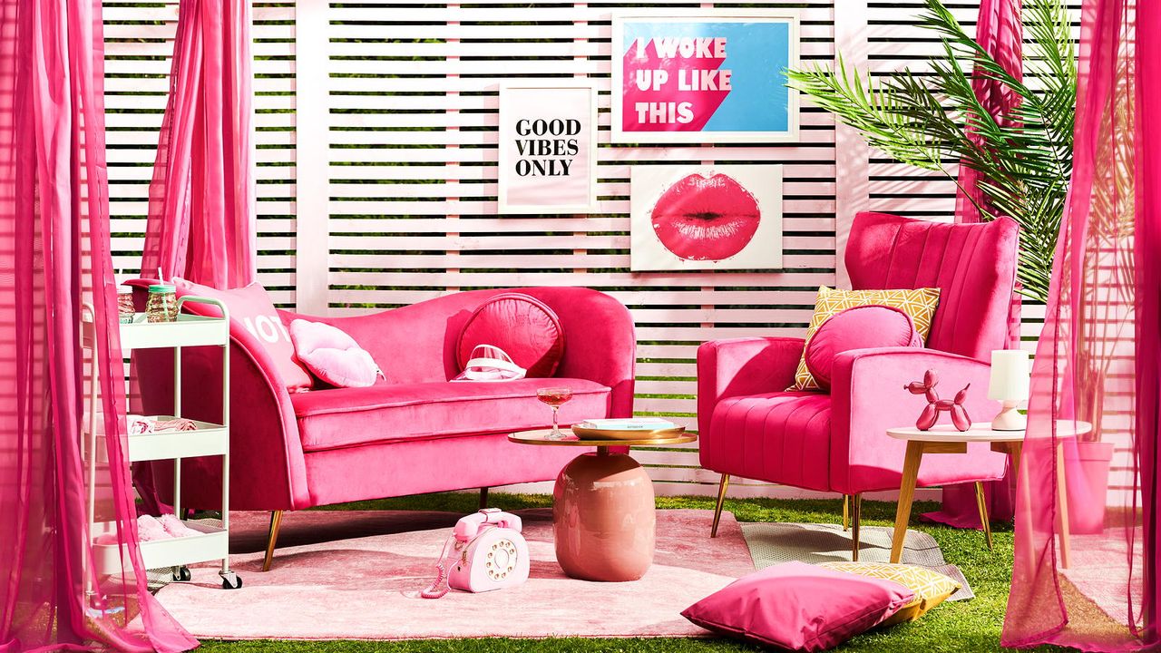 pink garden party with pink fence and pink sofa in pergola