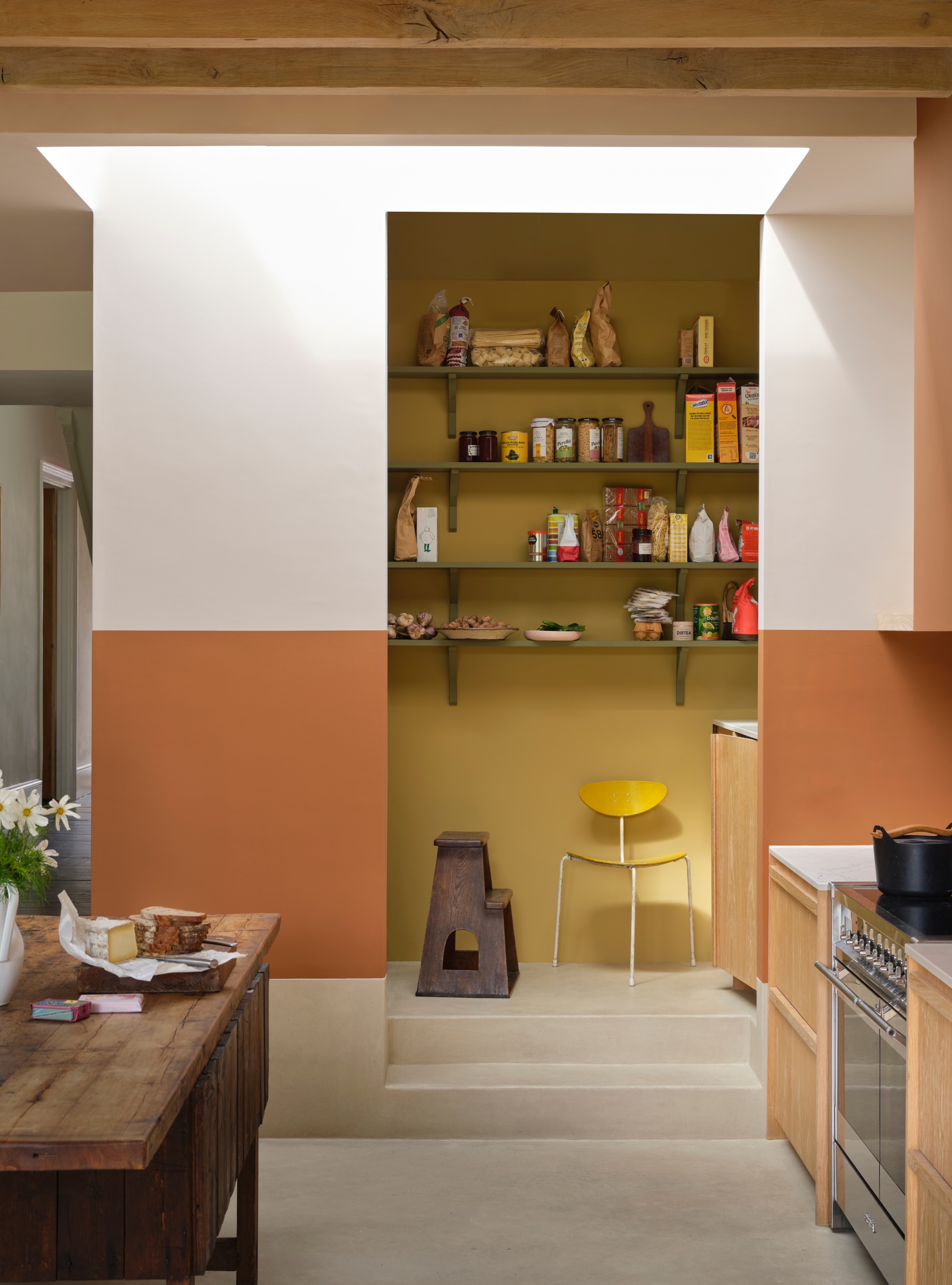 Tonal kitchen in ochre and terracotta with white walls