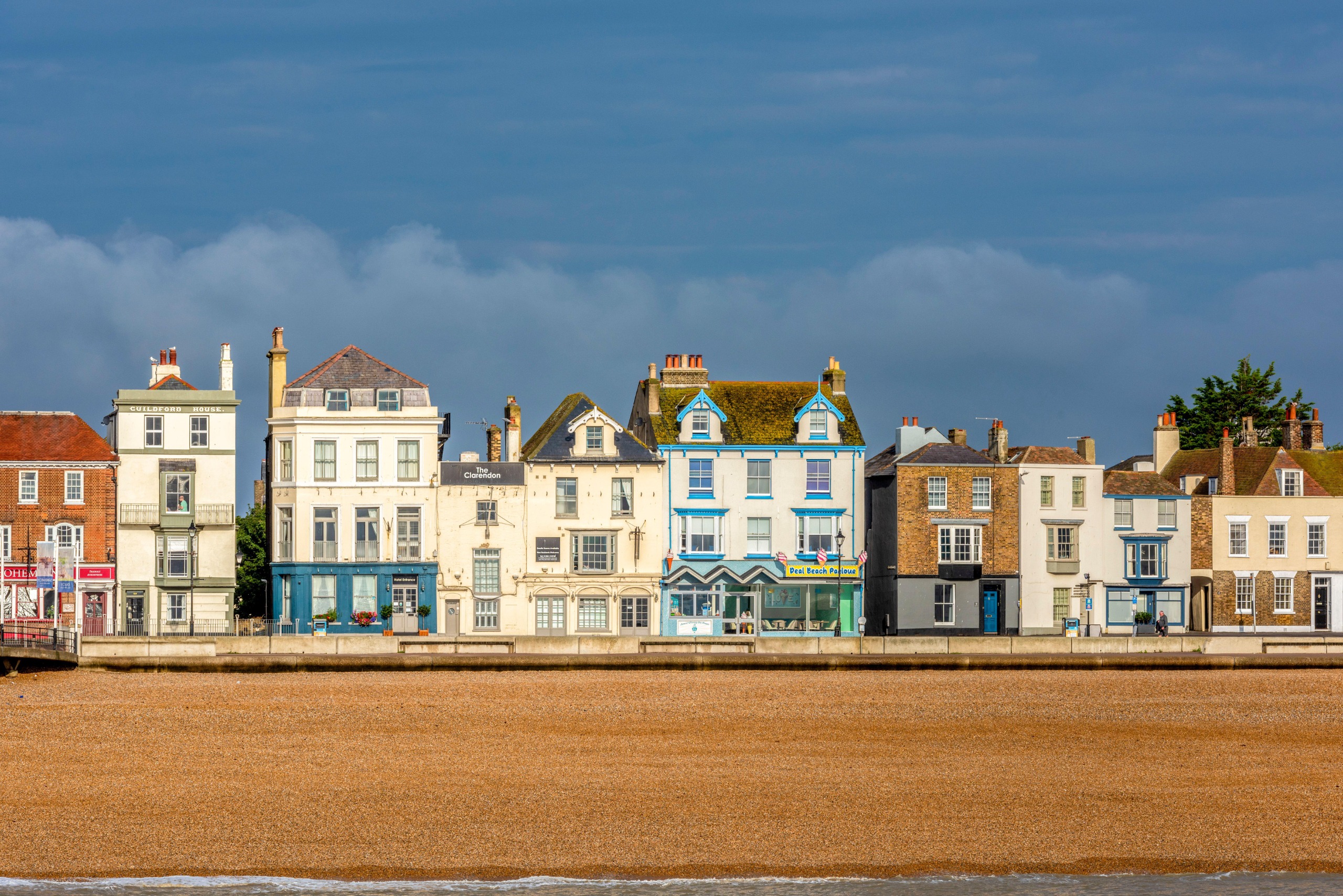Parade of seafront white and brick Victorian shops and houses in Deal
