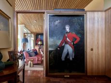 Fig 1: The hall with a portrait of the 4th Baronet (1774–1834), attributed to Sir William Beechey, set into panelling modelled on a 1950s design for Turnhouse Airport. Leuchie Walled Garden, East Lothian. ©Paul Highnam for Country Life.