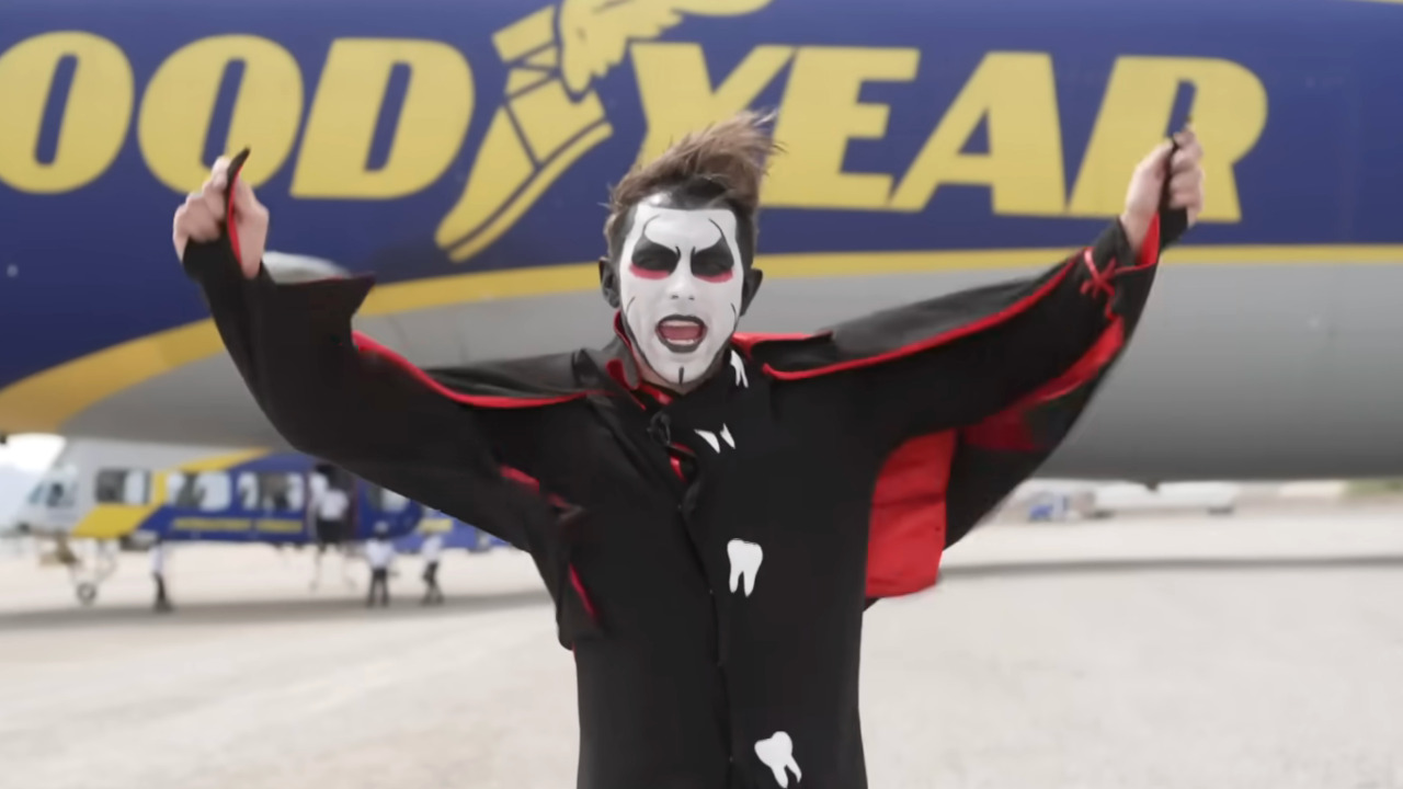 Danhausen poses in front of the Goodyear Blimp.