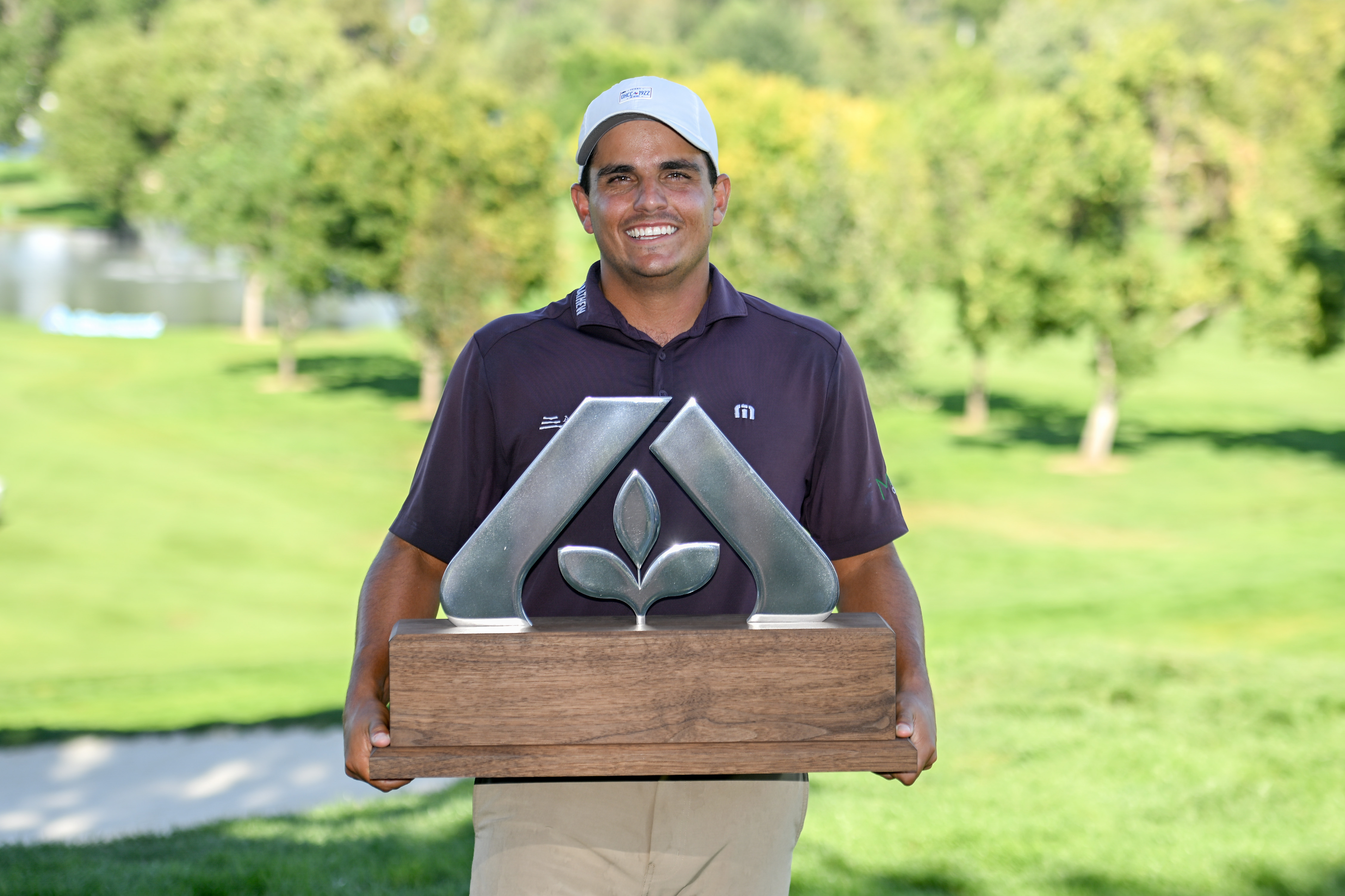 Emilio Gonzalez holds a trophy