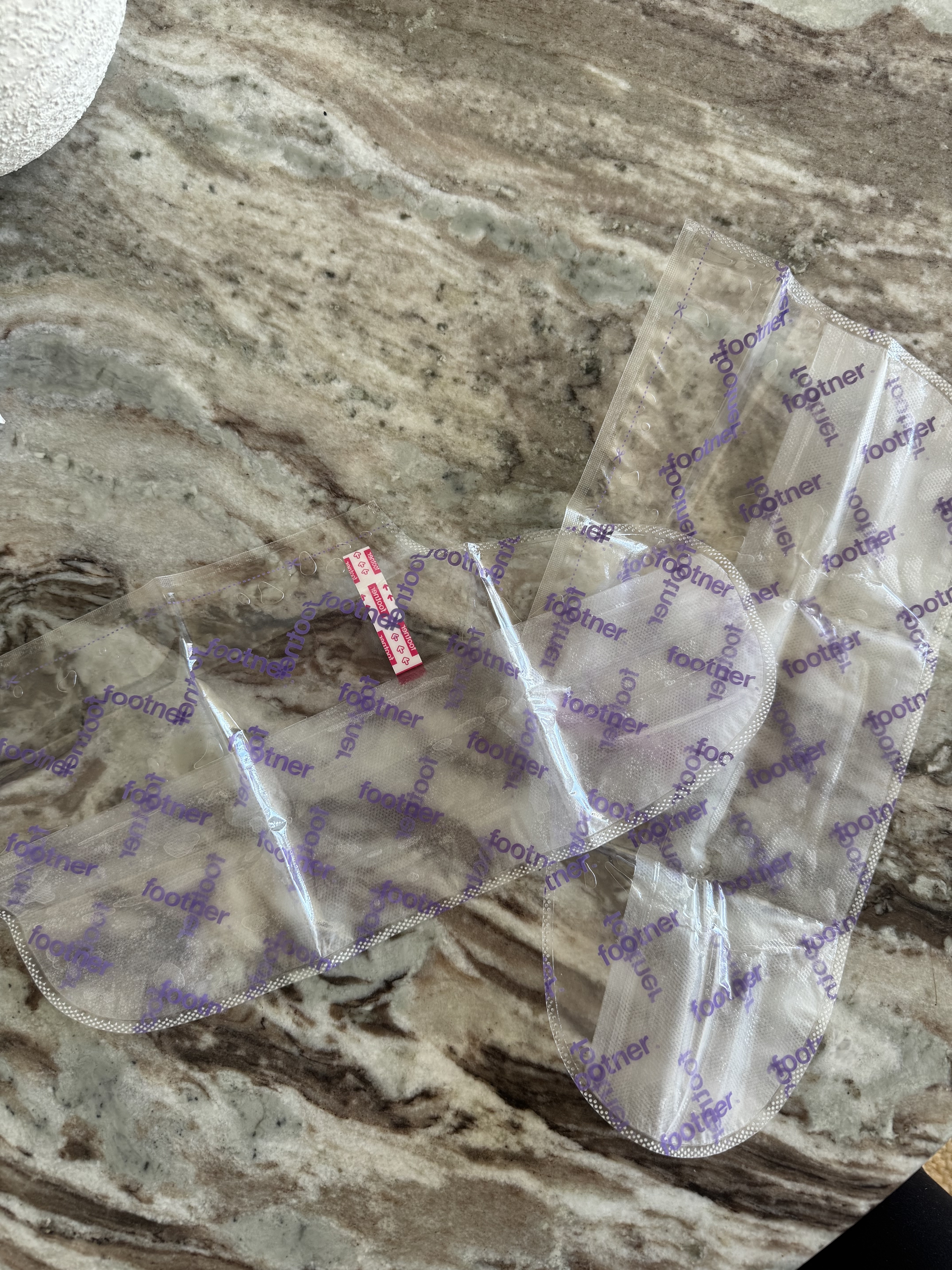 A photo of the Footner socks unboxed, which are two large clear socks