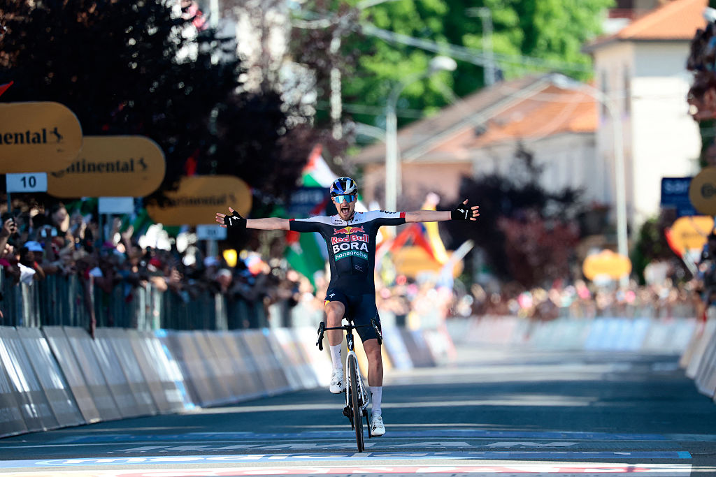 Red Bull-Bora-Hansgrohe's Germany rider Nico Denz celebrates after victory as he crosses the finish of the 18th stage of the 108th Giro d'Italia cycling race of 144kms from Morbegno to Cesano Maderno on May 29, 2025. (Photo by Luca Bettini / AFP)