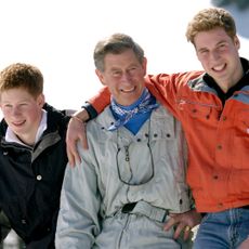 Prince Harry, King Charles, and Prince William smile during a skiing trip