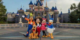 Mickey Mouse and other costumed characters in front of Sleeping Beauty's Castle at Disneyland