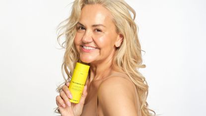 Caroline Hirons holding The Strong Acid from her skincare line Skin Rocks