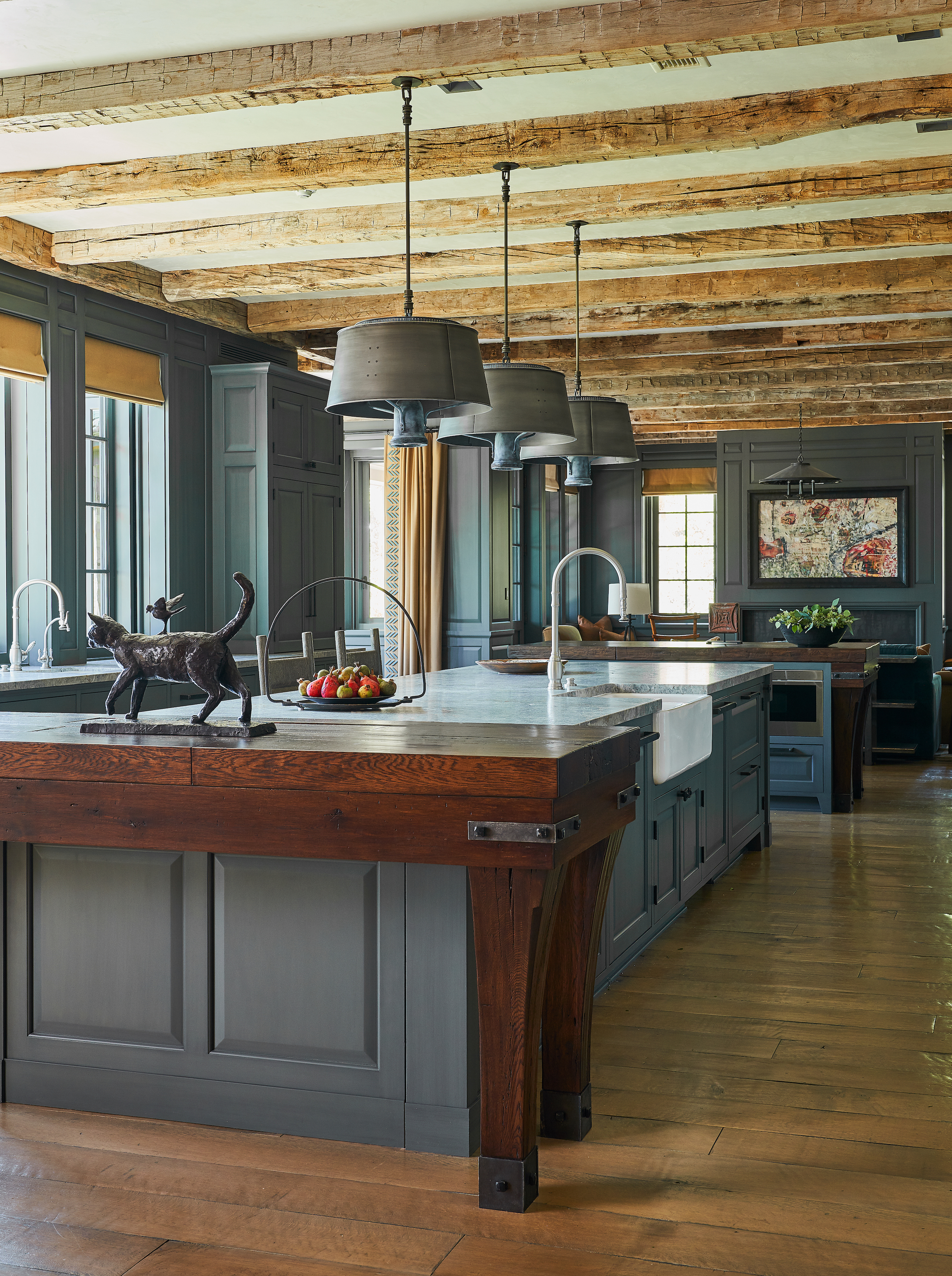 Cozy painted kitchen cabinet ideas in dark gray, with rustic timber beams and wooden flooring in a traditional country scheme.