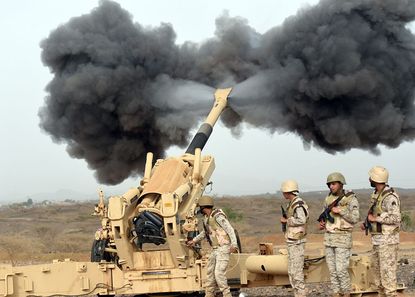 Saudi Arabian soldiers fire shells toward Yemen.