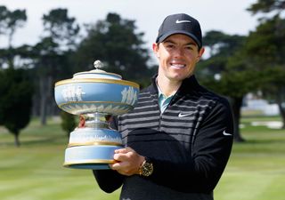 McIlroy holds a trophy
