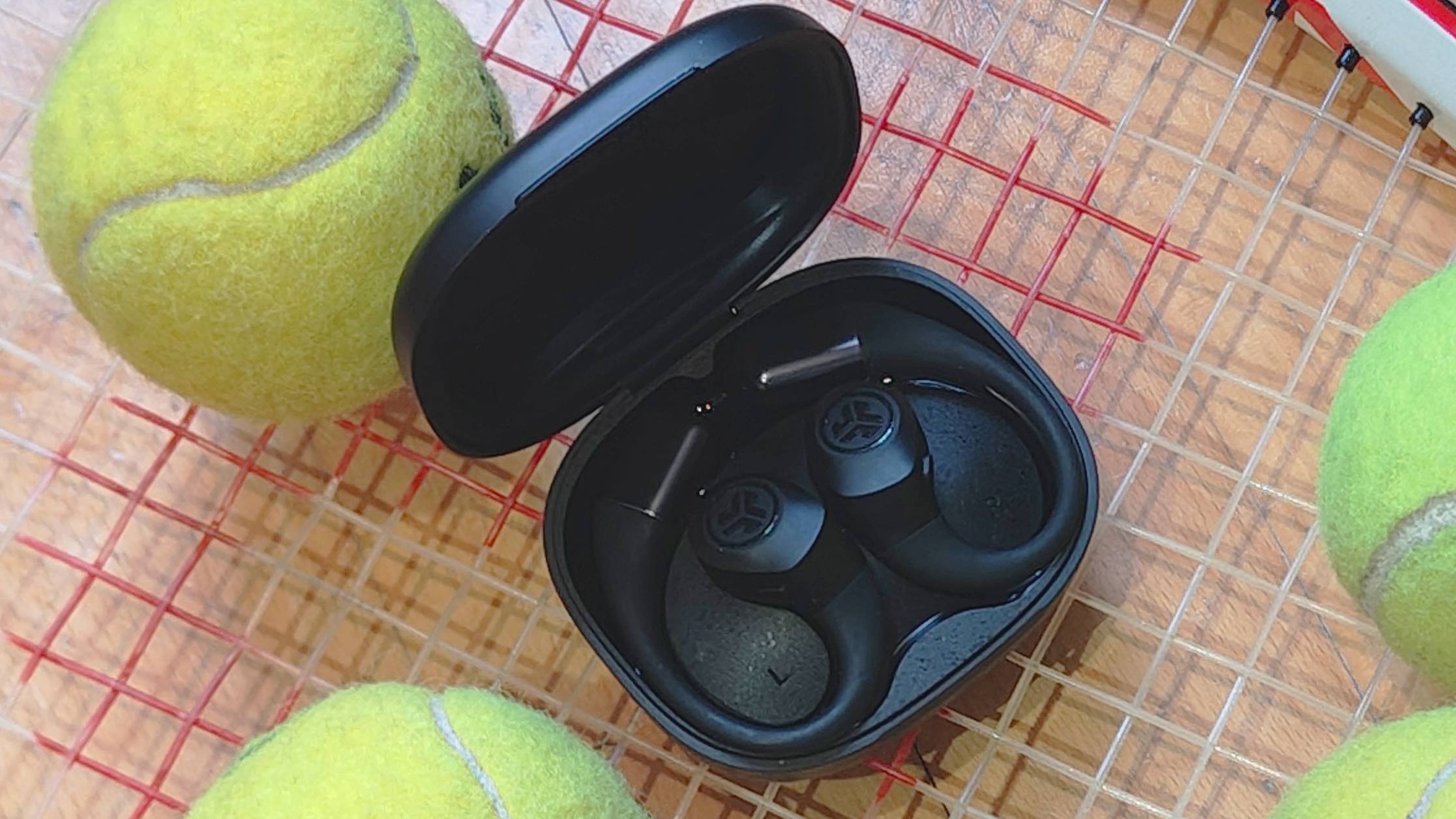 The JLab Epic Open Sport on a tennis racquet.