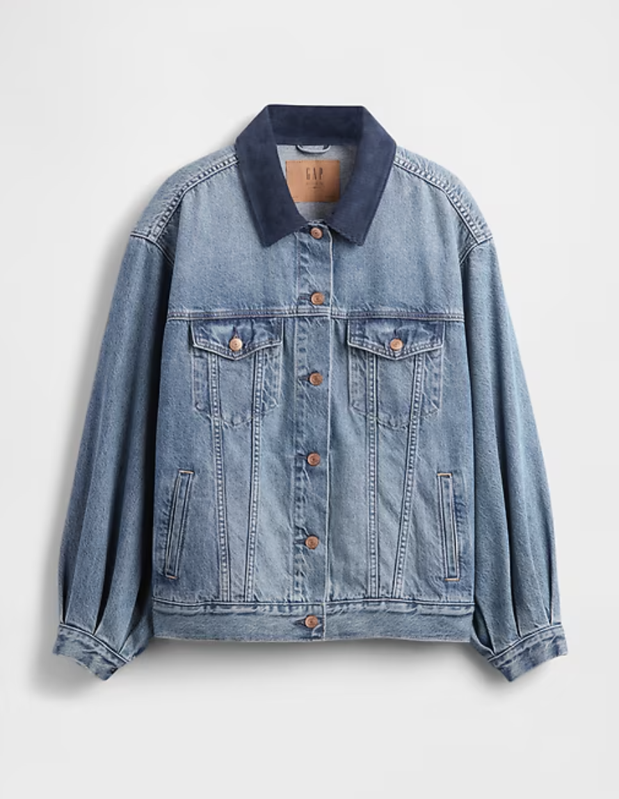 a gap x doen jean jacket in front of a plain backdrop