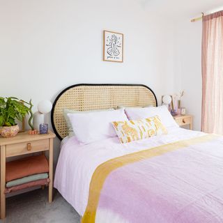 bedroom with cane headboard and pink duvet cover