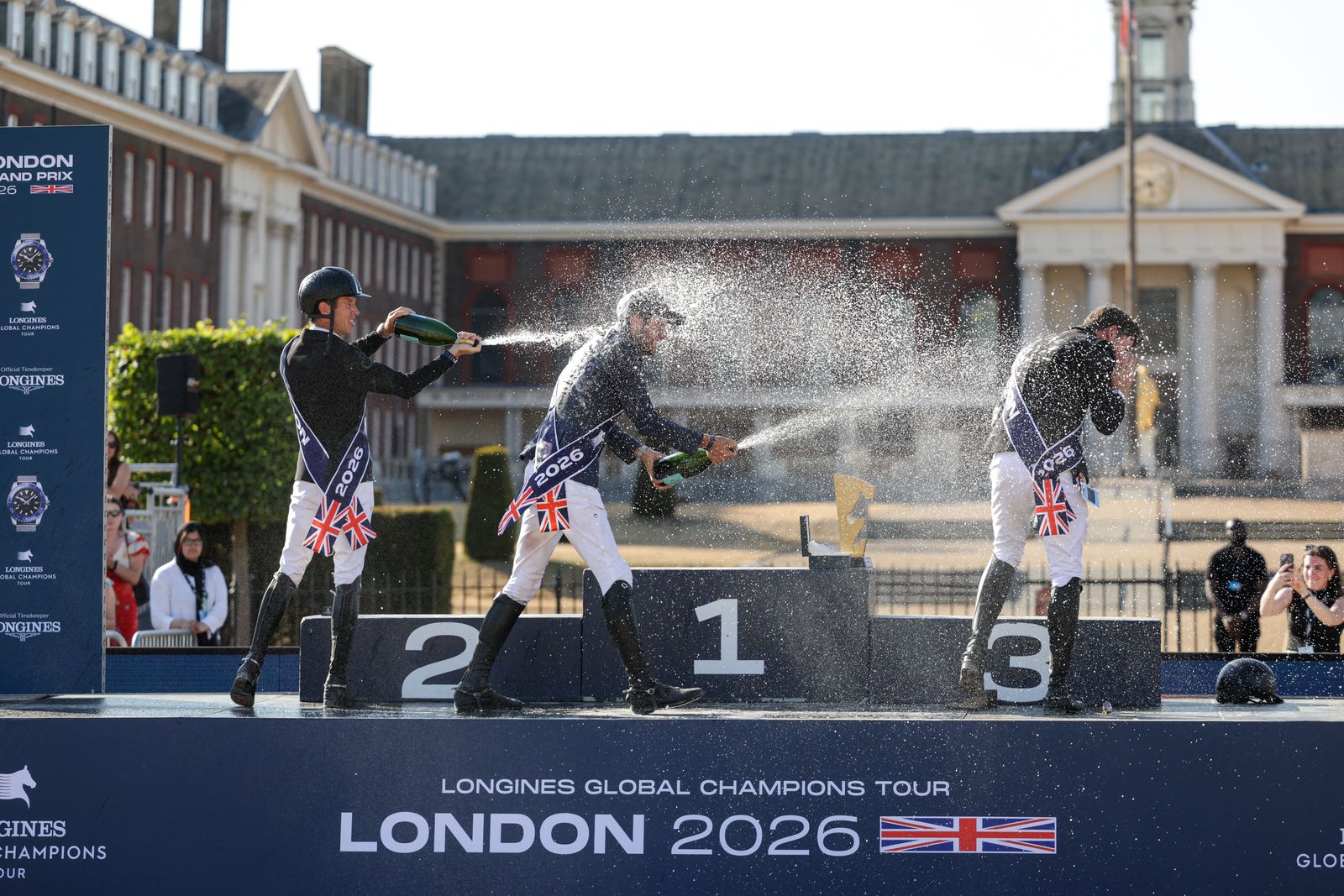 Christian Kukuk, Scott Brash and Harry Charles enjoy the champagne on the podium for the Longines Global Champions Tour grand prix of London