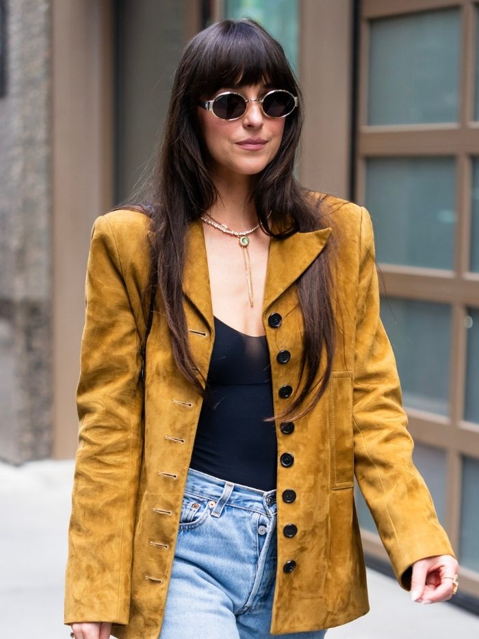 Dakota Johnson is seen in Midtown on May 30, 2025 in New York City, wearing jeans, a suede blazer and sunglasses