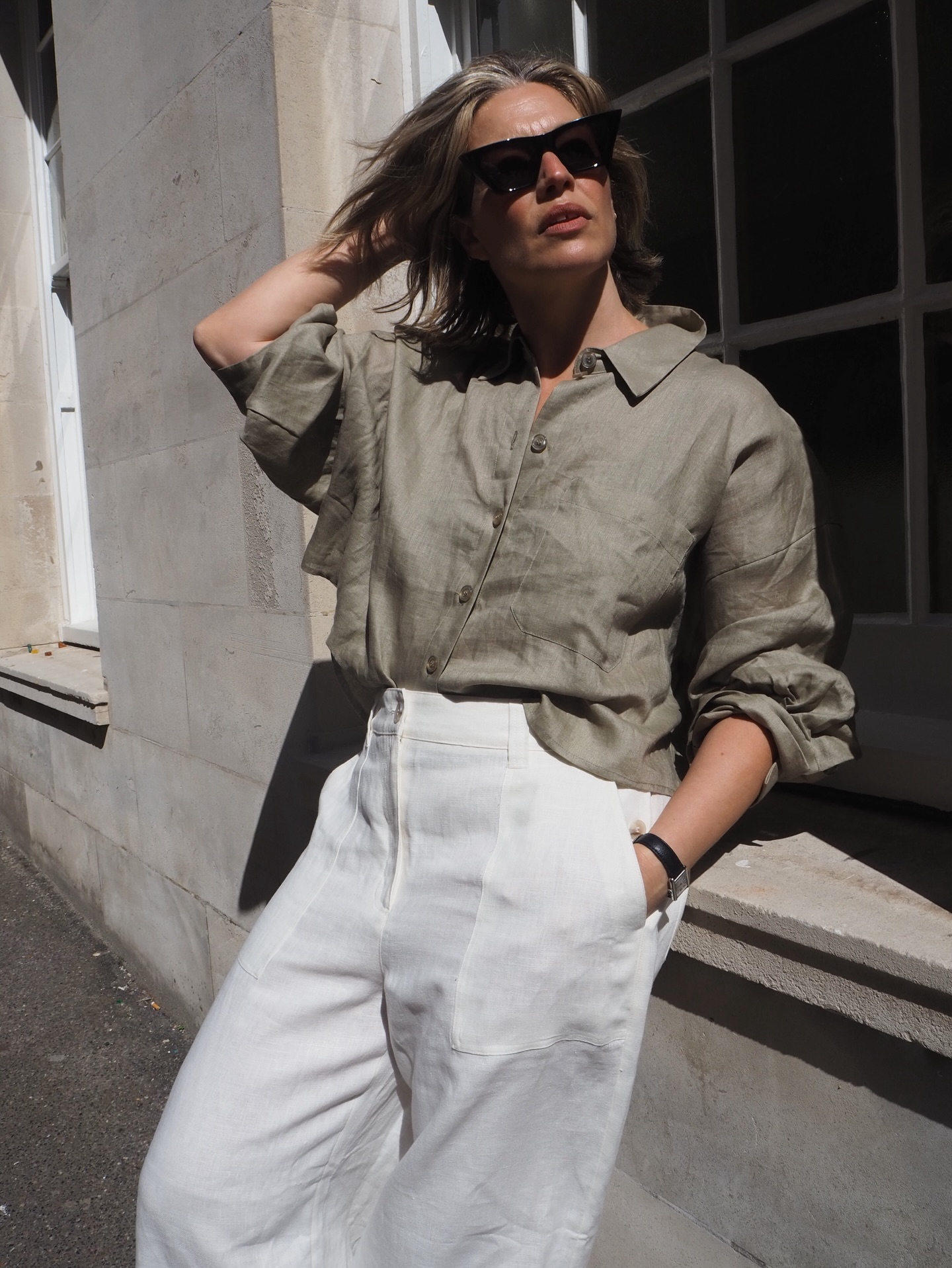 alexis foreman wears a khaki green shirt and white trousers