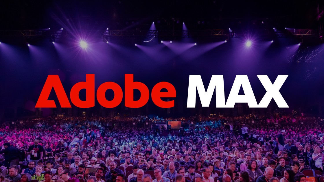 The Adobe Max logo overlaid on a packed conference hall, with a large audience seated beneath purple stage lights.