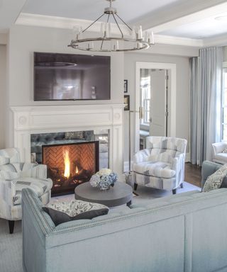 bedroom fireplace with two armchairs and fire lit