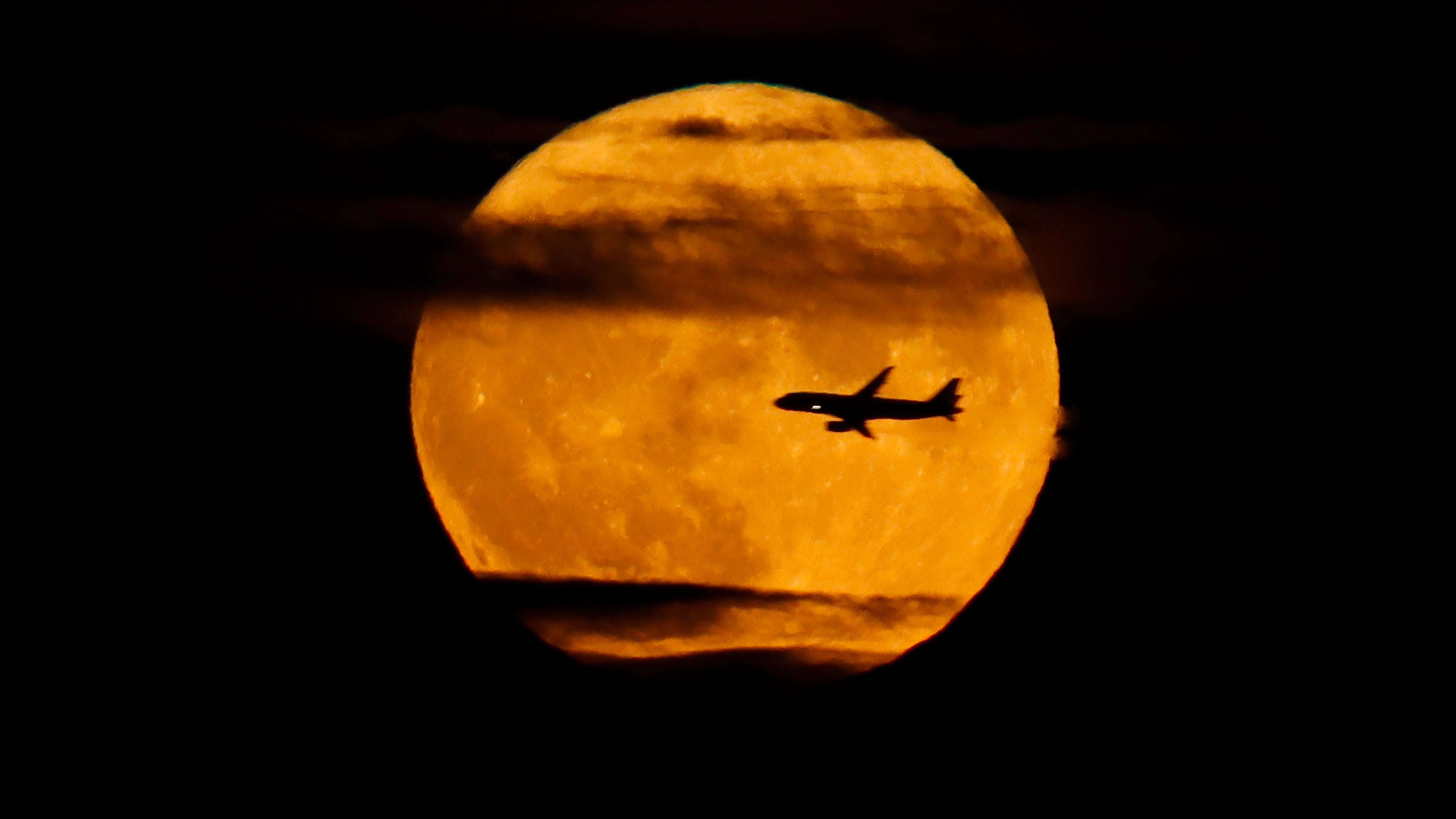 airplane in front of supermoon