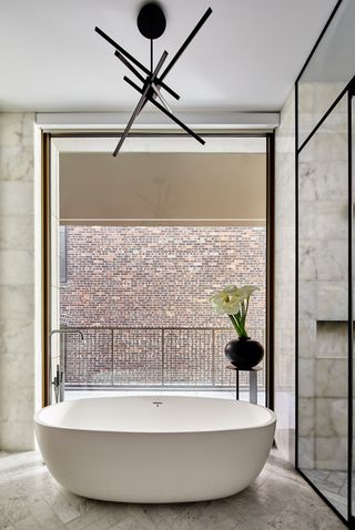 a modern bath in front of a large window