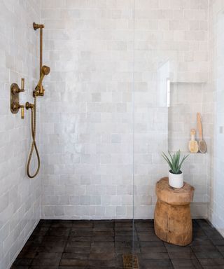 Rustic bathroom with zellige tiled shower and wood stool