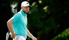 Daniel Berger watches on whilst walking the fairway