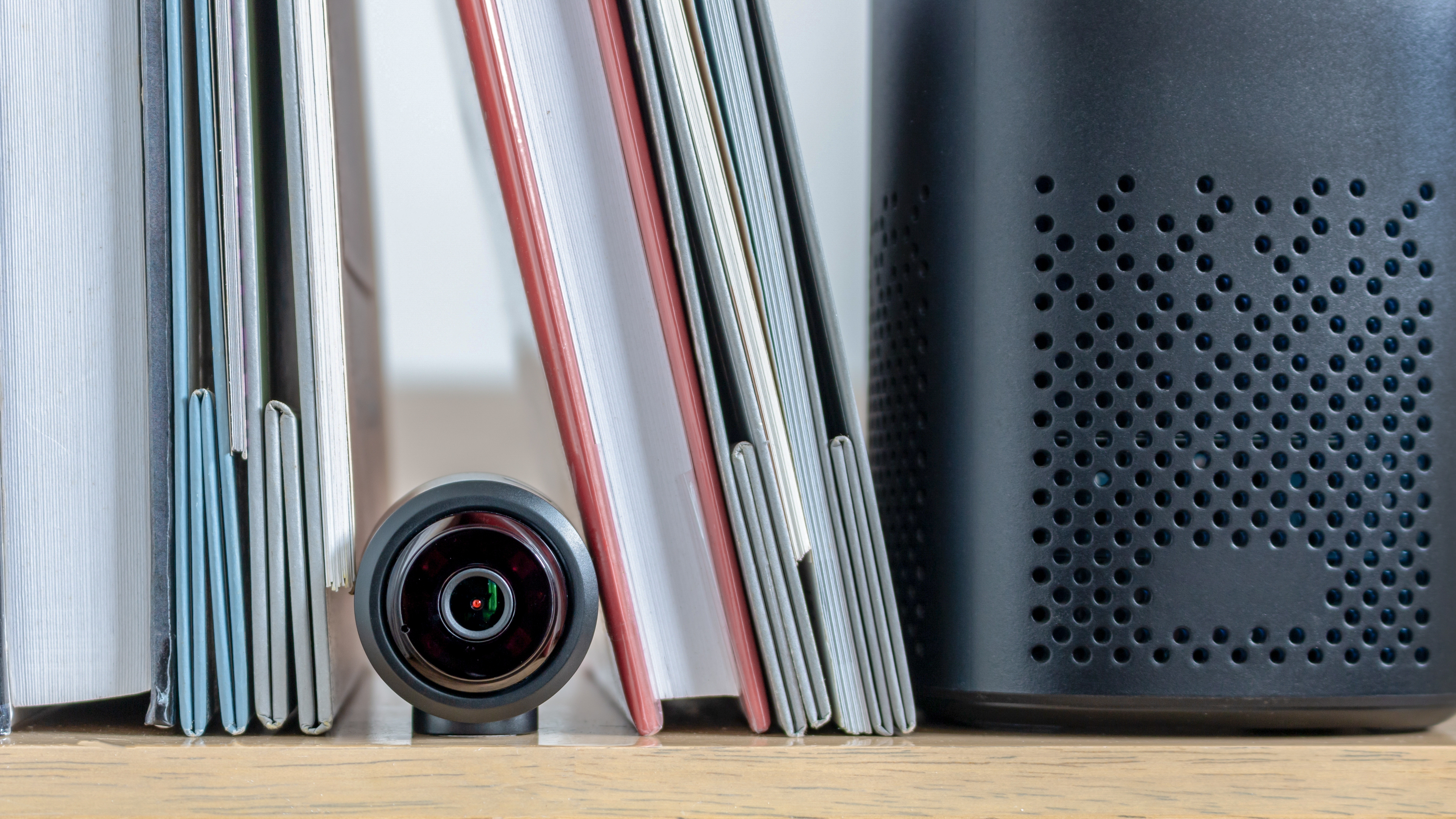 A small security camera hidden in a bookshelf
