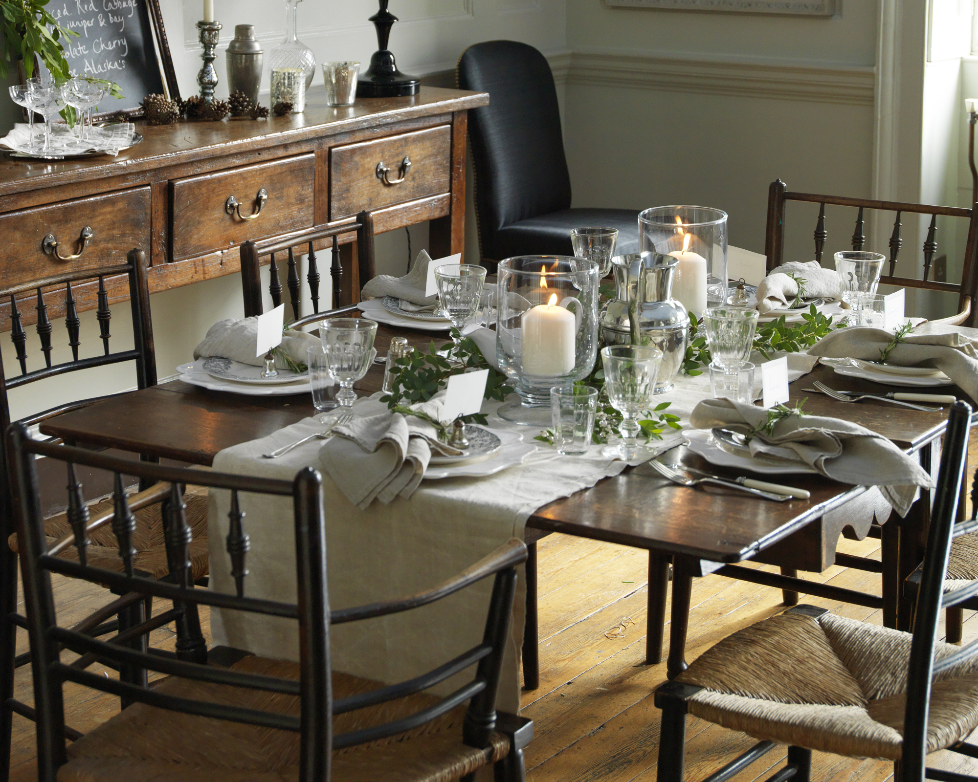 Thanksgiving table decor ideas with grey linen and foliage runner and crystal glassware