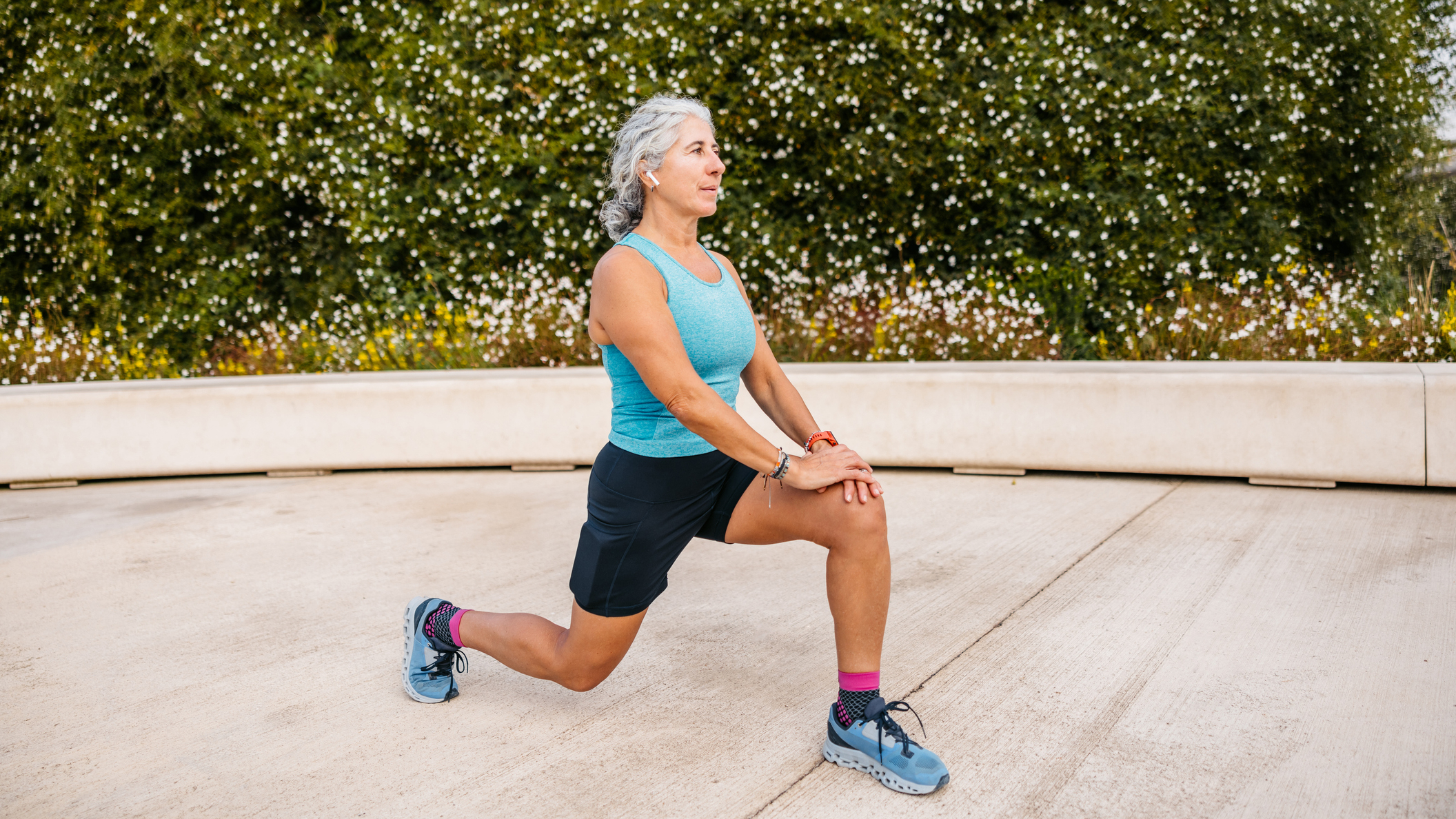 Woman in running clothes in the lunge position