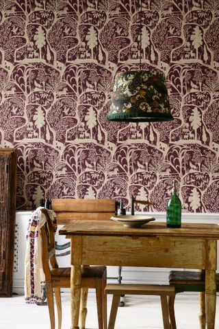 wildlife wallpaper in rustic dining room, old vintage table and chairs