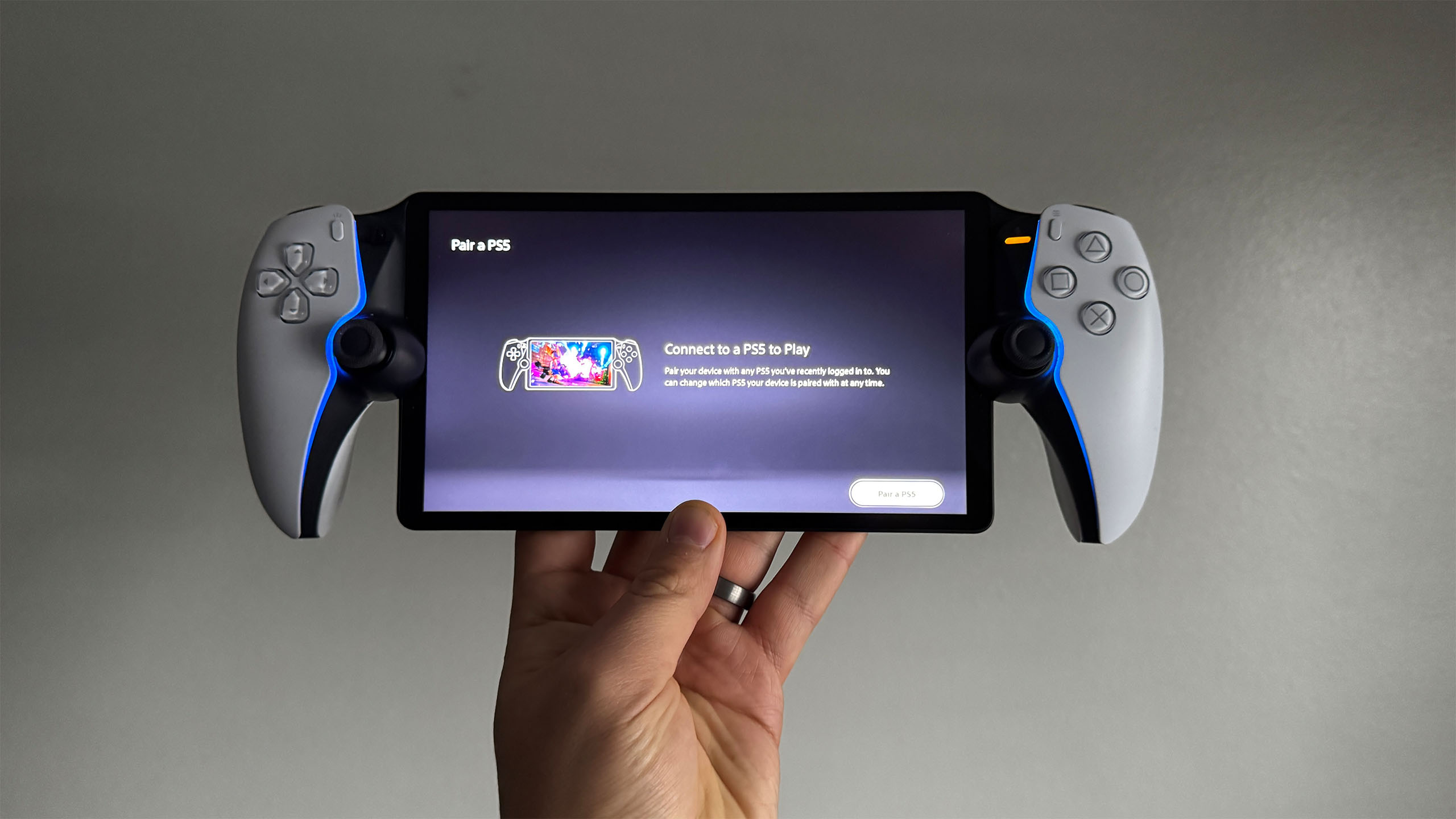 The PlayStation Portal being held in a hand.