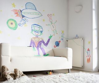 Child's drawings on wall in living room