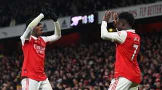 Eddie Nketiah of Arsenal celebrates with teammate Bukayo Saka after scoring their team's third, winning goal during the Premier League match between Arsenal and Manchester United on 22 January, 2023 at the Emirates Stadium in London, United Kingdom.