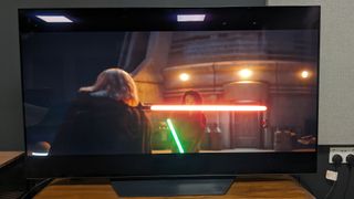 LG B3 showing two characters with lightsabers in green and red