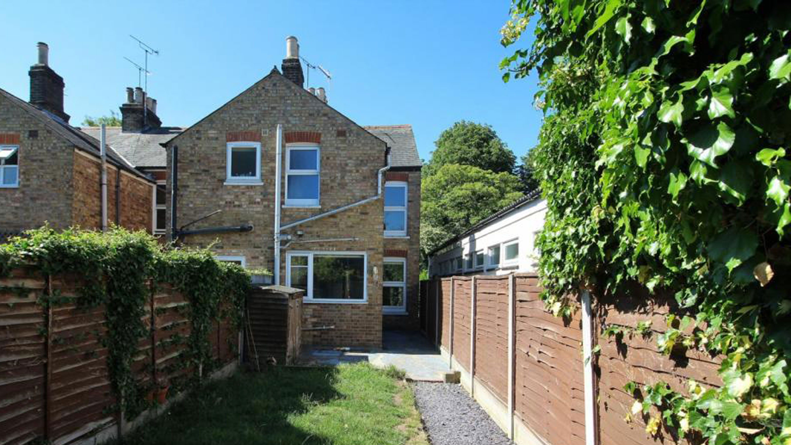 Exterior of stones house with long terrace garden