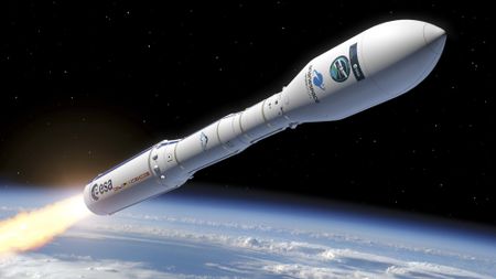 a white rocket fires flames from its engines as it flies above a curve of the Earth into space.