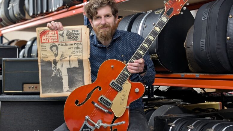 Luke Hobbs, head of the guitar department at Gardiner Houlgate, holding the 1957 Gretsch Chet Atkins 6120 guitar once owned by Jimmy Page
