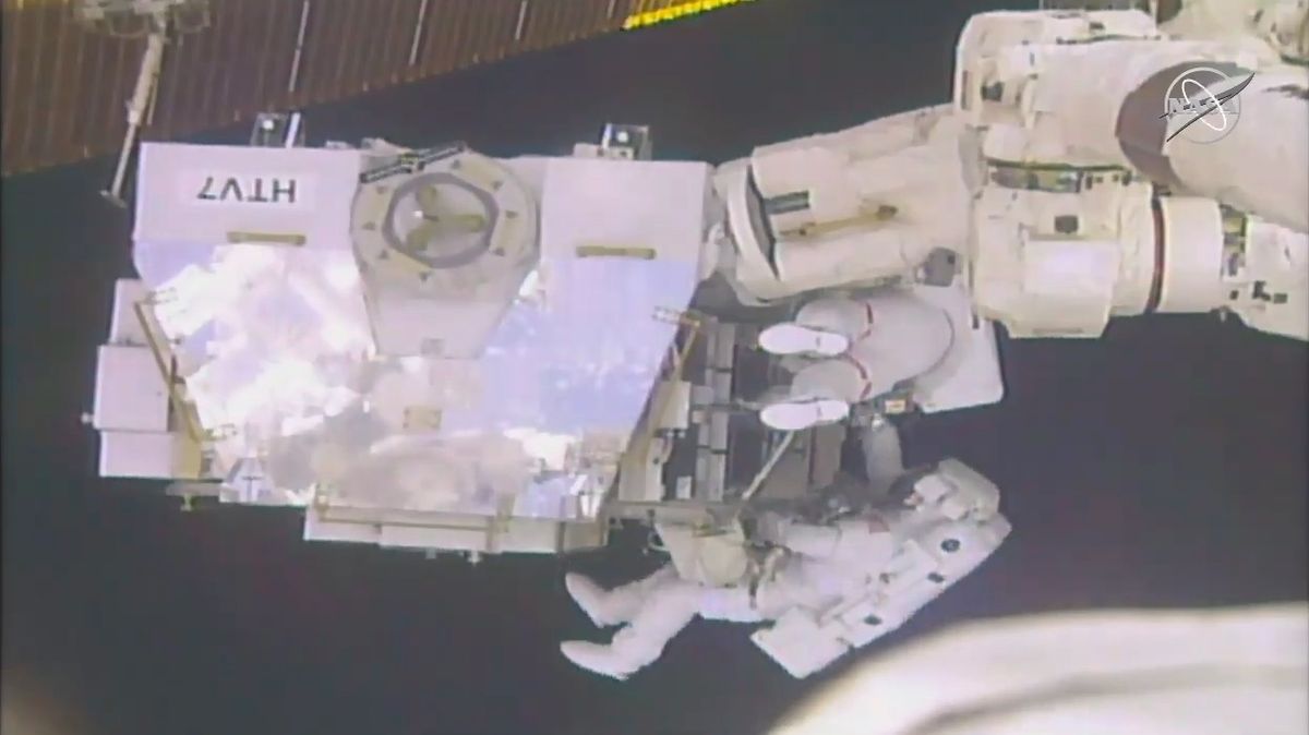 NASA astronauts Anne McClain and Nick Hague work outside the HTV-7 external palette.