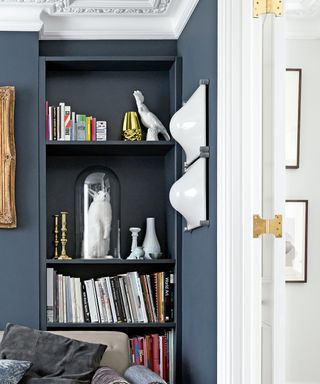Expert tips on sourcing, bookshelf with books and and other treasures in a living room
