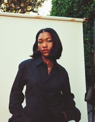 Demi Singleton wearing a dark navy button-down shirt.