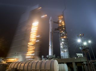 The SpaceX Falcon 9 rocket carrying InSight sits on the launch pad at Vandenberg Air Force Base prior to launch. The blurred lights are from the mobile service tower being rolled back.