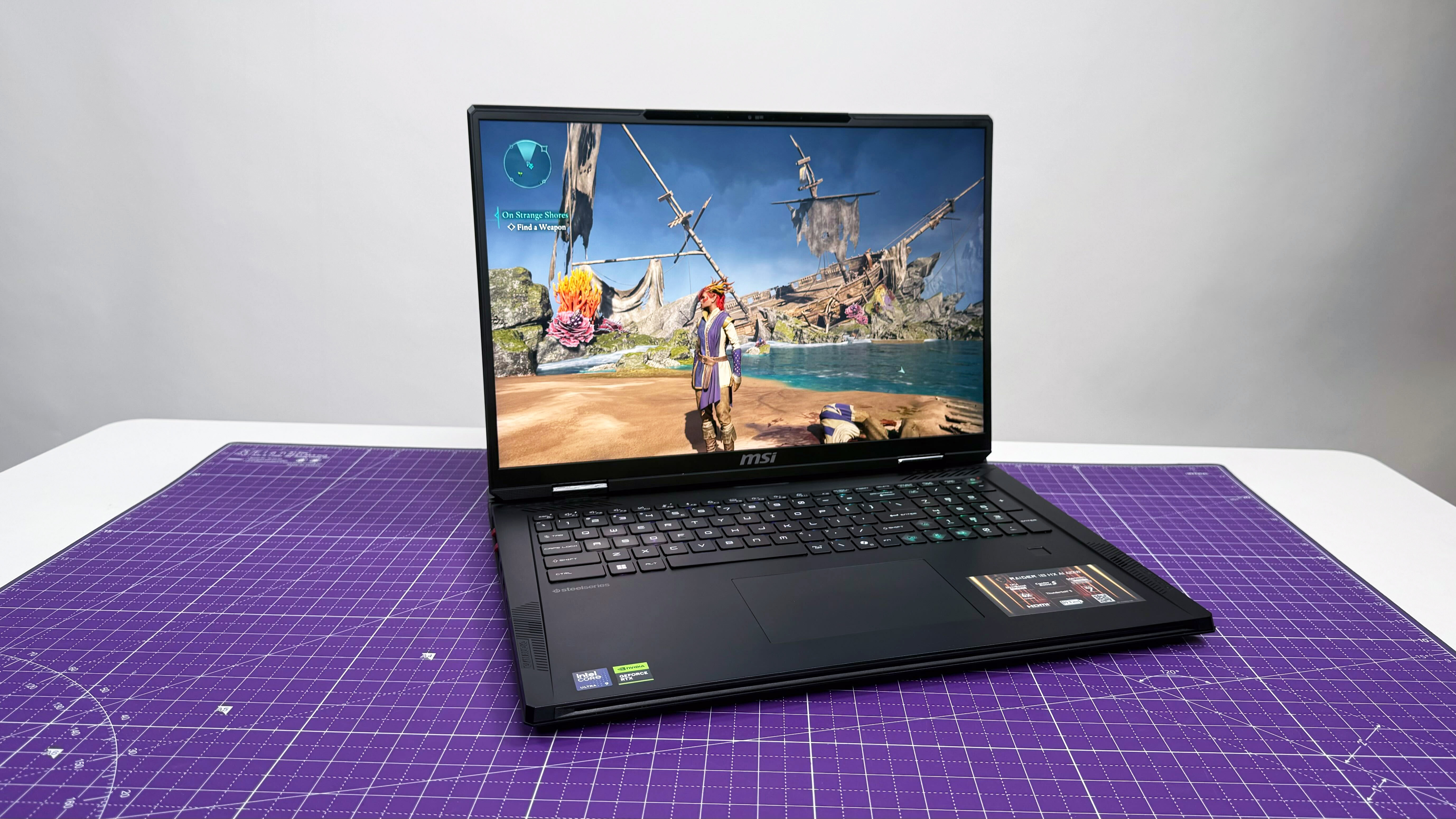 MSI Raider 18 HX AI gaming laptop open facing on a purple mat against a gray background.