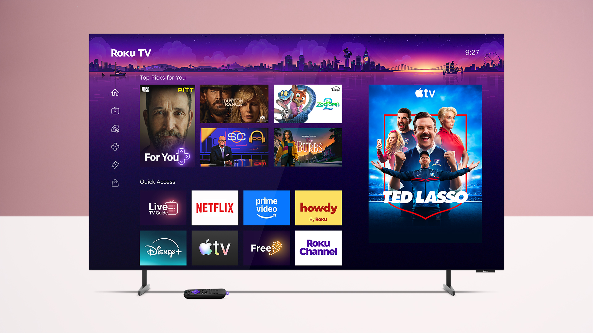 The Roku Pro Series OLED TV on a white table against a pink background, with its remote underneath it