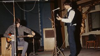 Ray Davies (left) and his brother Dave Davies, of The Kinks, at a soundcheck before a session for the BBC at the Playhouse Theatre, London, 7th September 1964.
