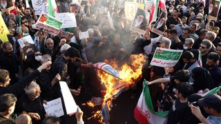 Pro-government protesters burned flags of the US, Israel and Britain during a rally against the recent anti-government protests in Tehran and across the country.