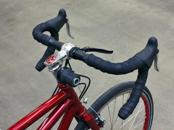 The Rohloff shifter is only meant to go on a mountain bike handlebar so a custom mount built into an extra-tall headset spacer is used instead.