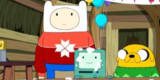 Jake, Finn and their little game cube in Adventure Time.